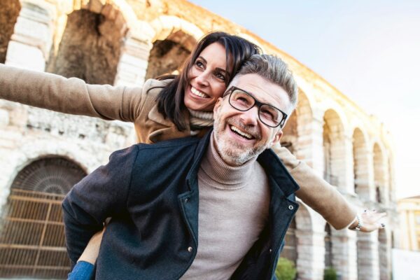 Married couple of tourists walking on city street visiting Italy