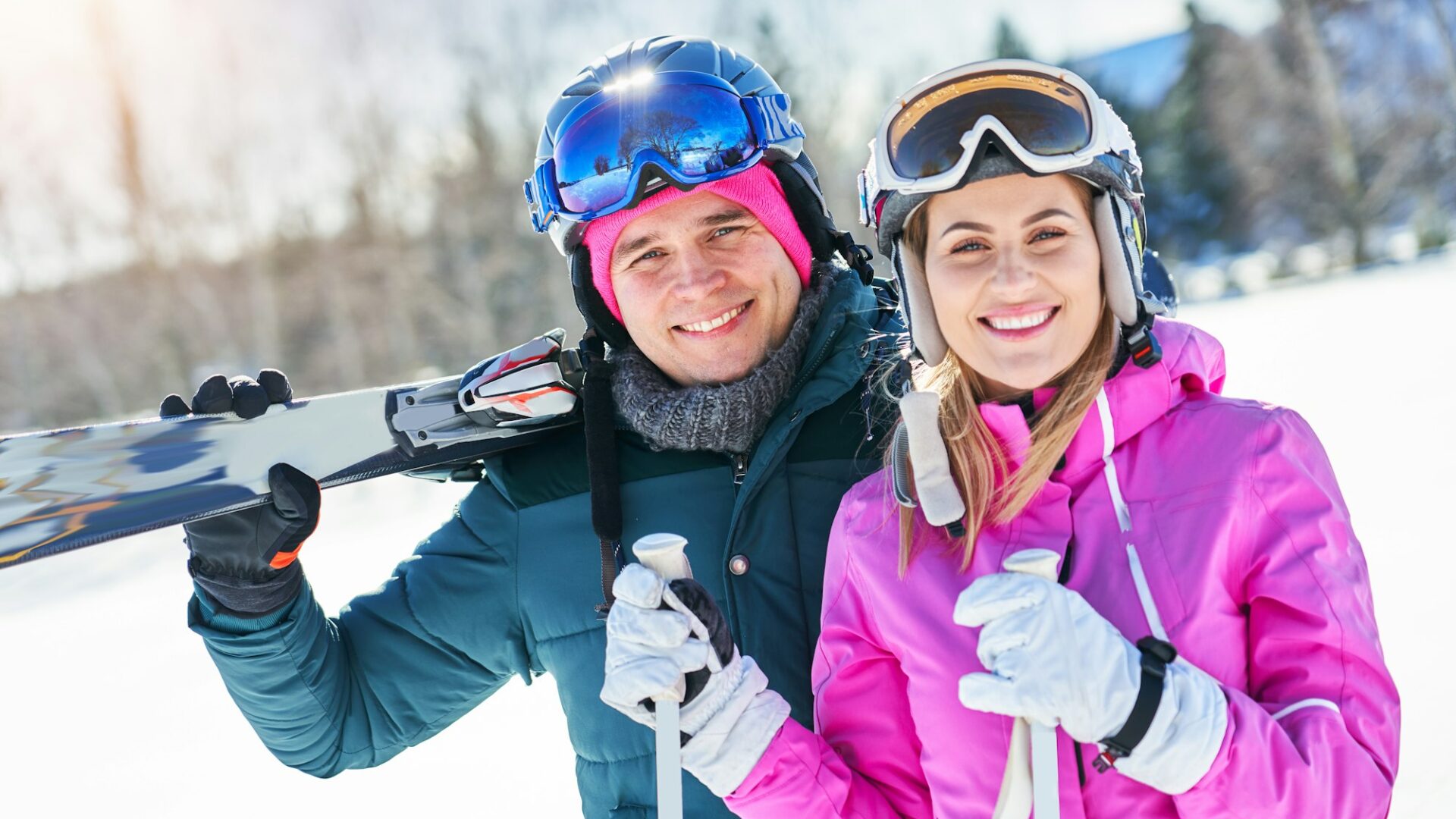 Young couple having fun while winter skiing