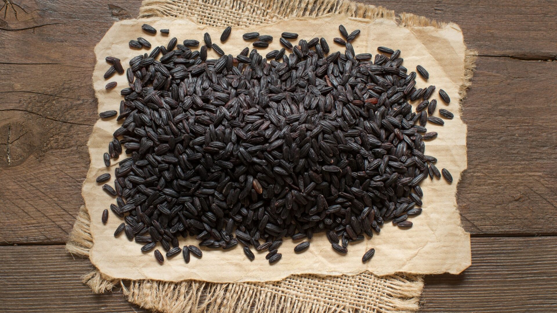 Black rice on a wooden table