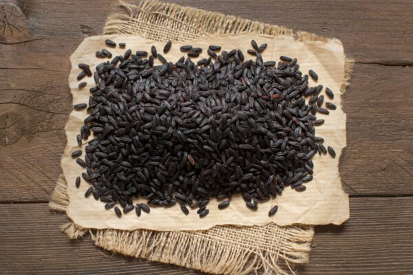 Black rice on a wooden table