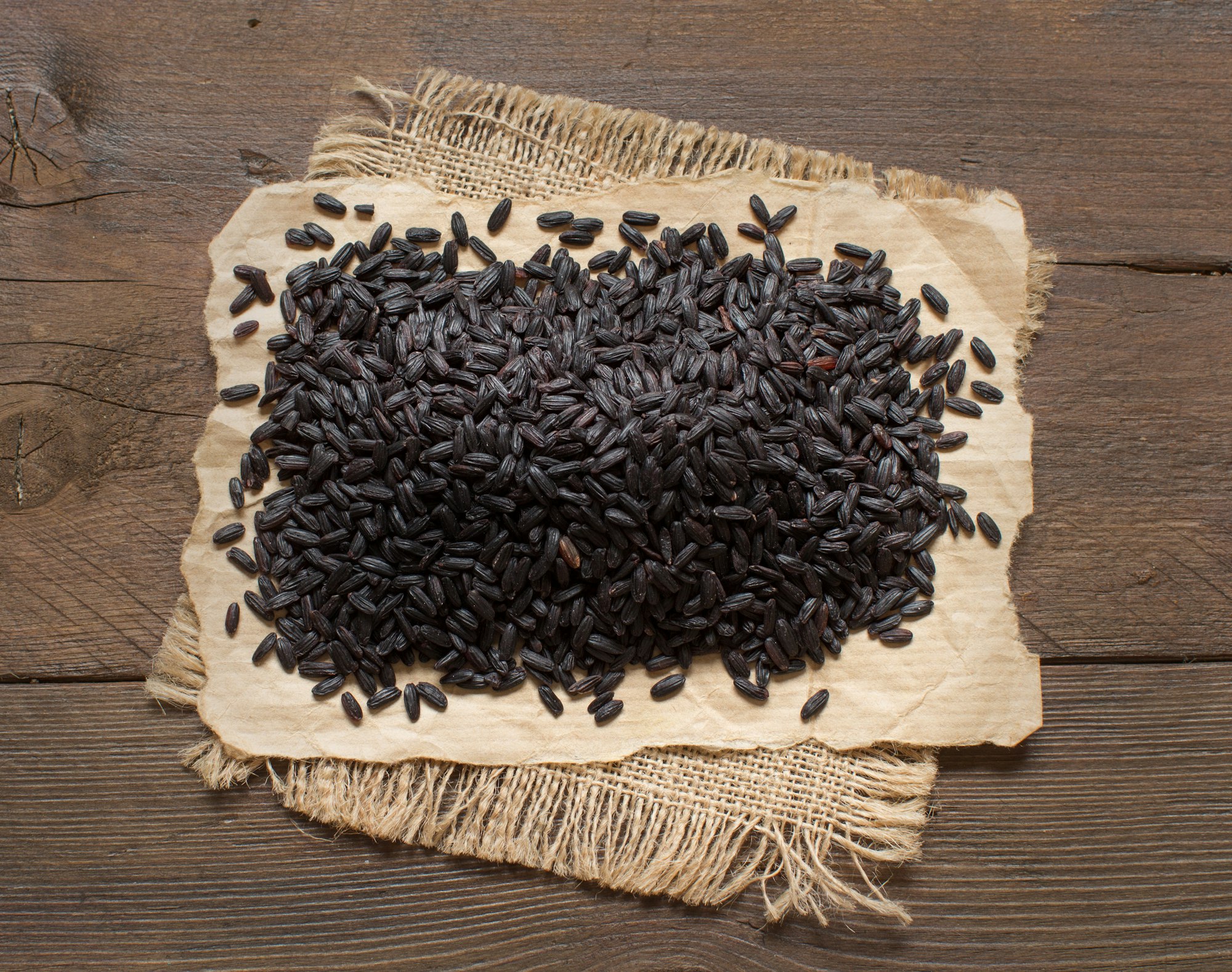 Black rice on a wooden table