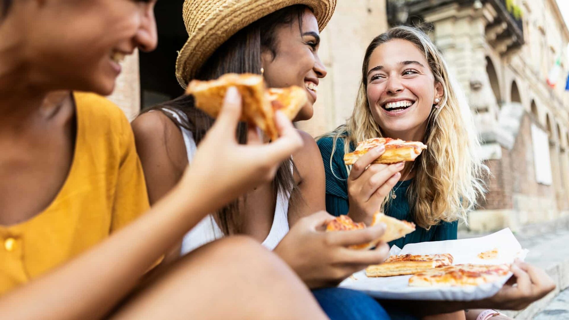 Happy female friends enjoying holidays together in Italy