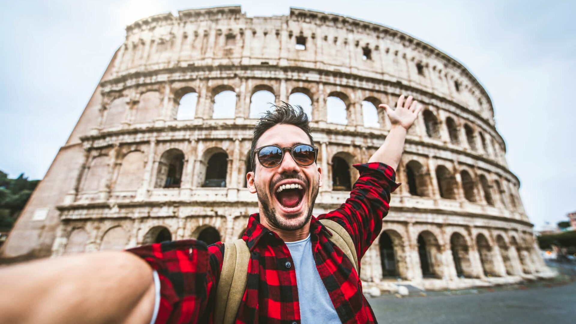 Happy tourist visiting Colosseum in Rome, Italy