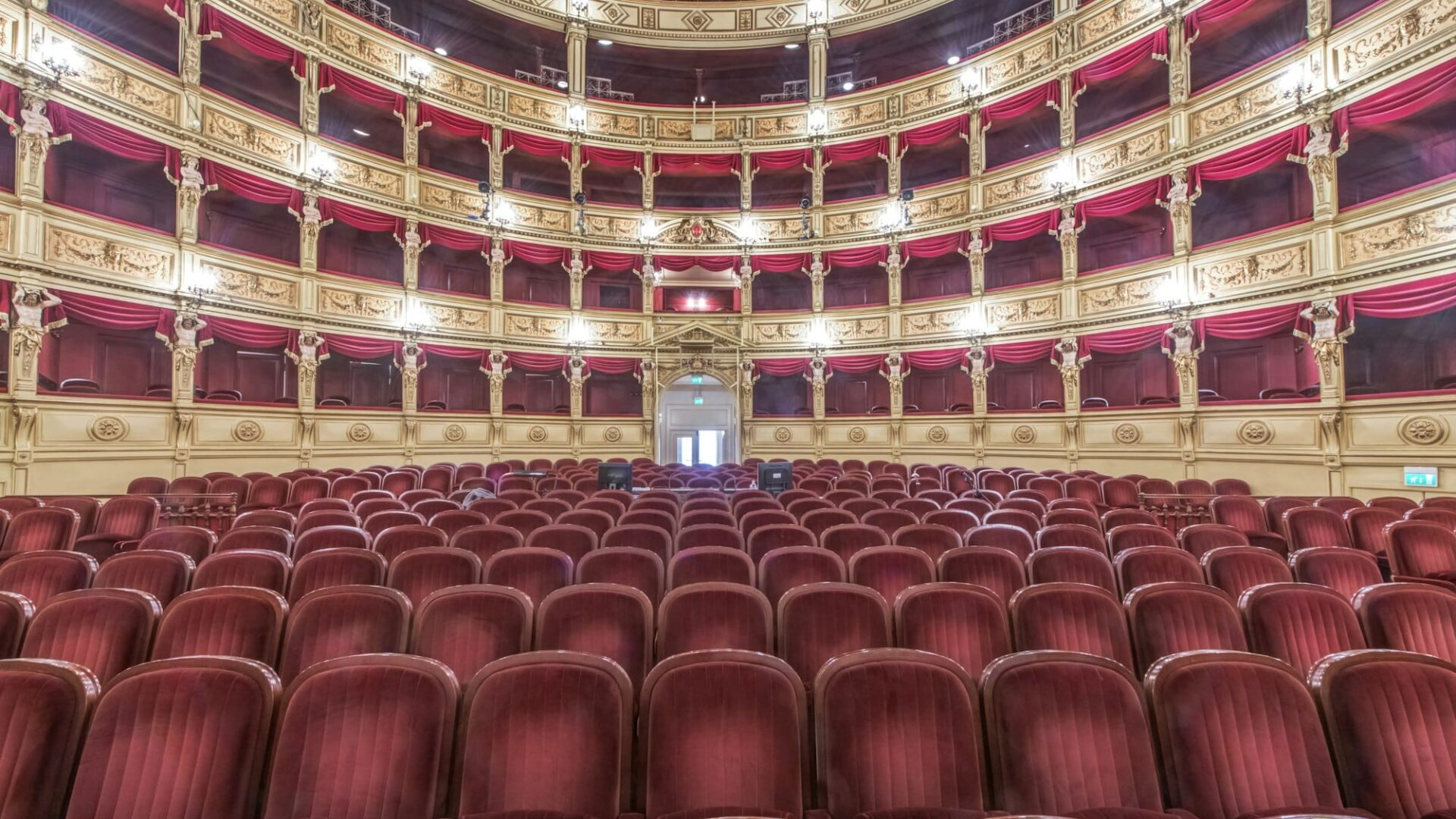 Interior of the Teatro Verdi, red velvet seats in the auditorium, Trieste, Italy.
