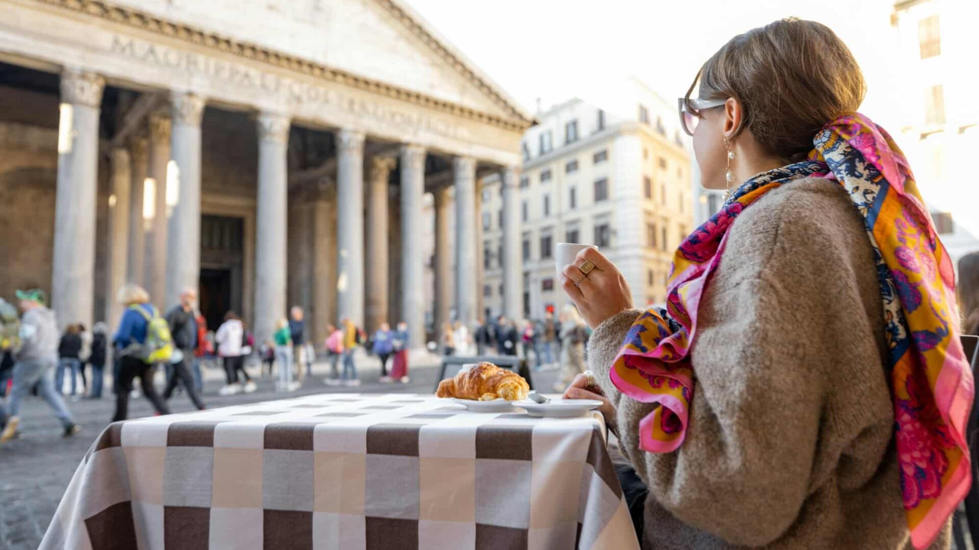 Woman sitting at outdoor cafe in Rome
