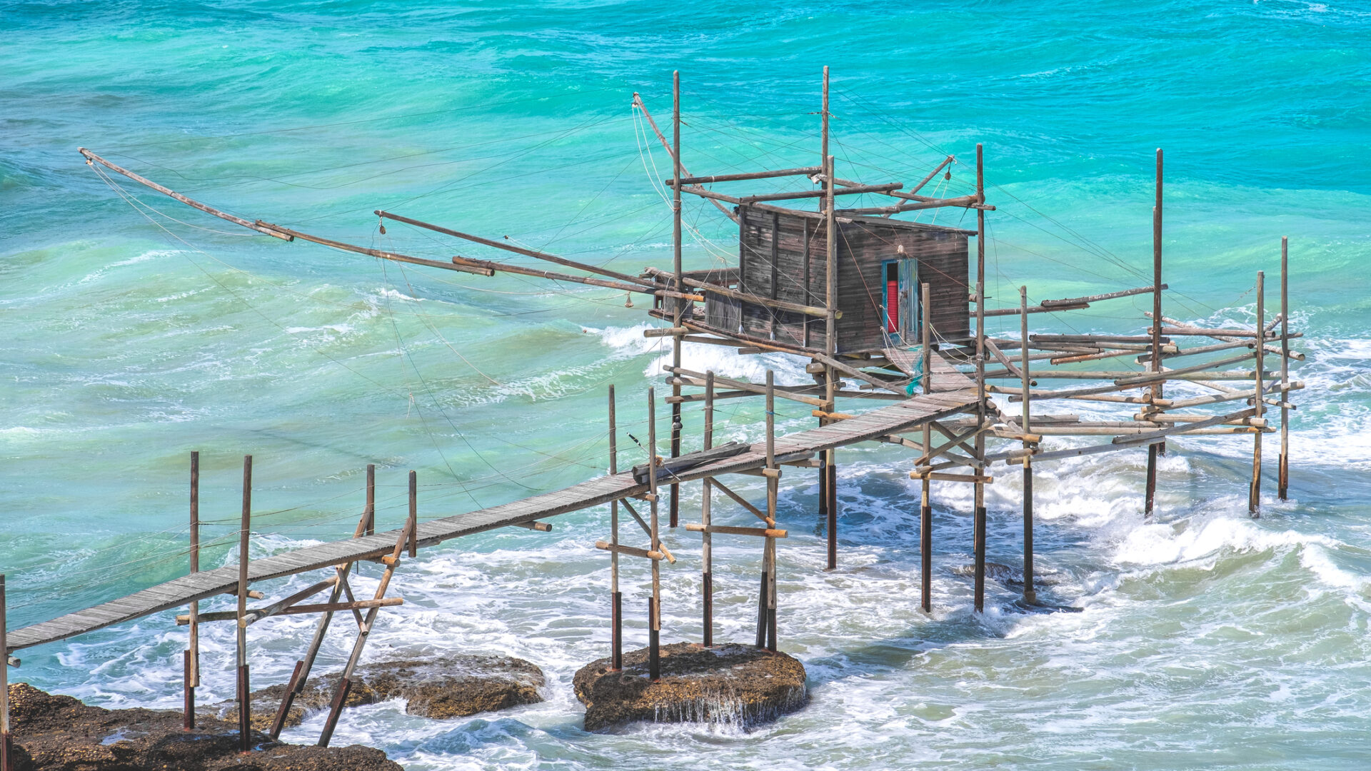 Trabucco fishing on turquoise sea, Italian coast.