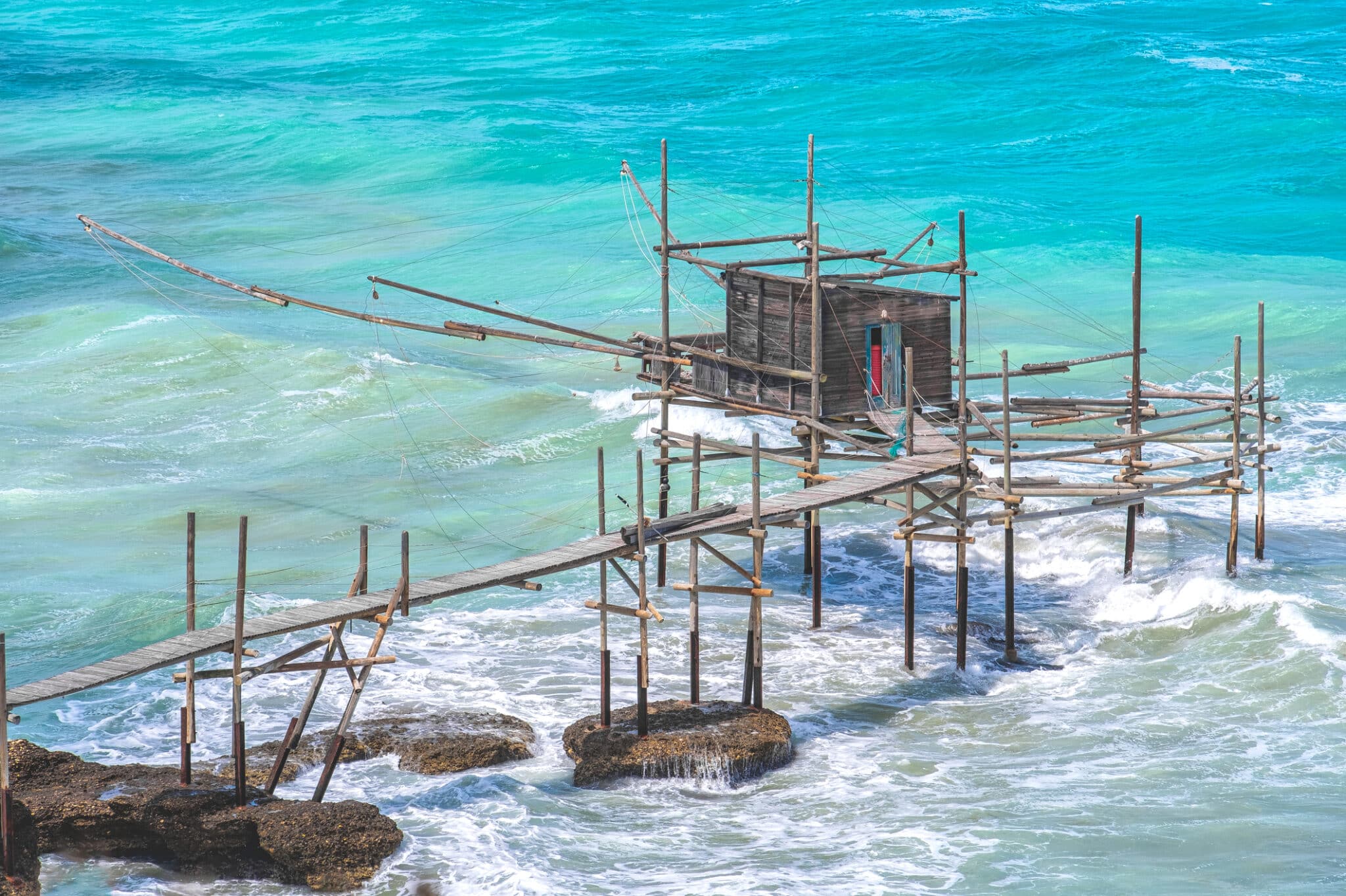Trabucco pesca su mare turchese, costa italiana.