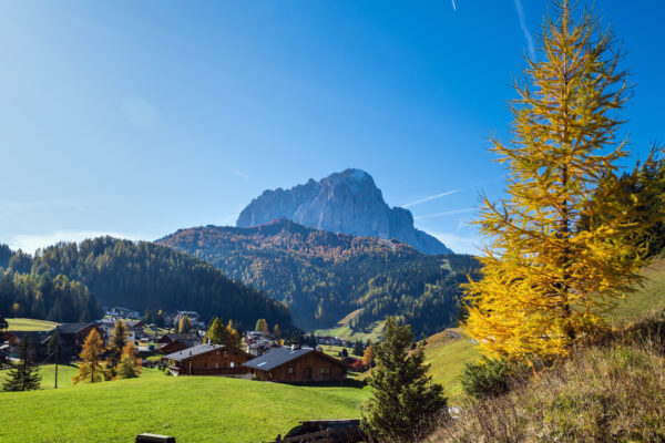 Otoñal pueblo de montaña con imponente montaña