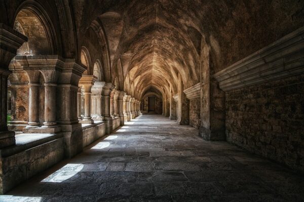 Corridor with stone arches and columns