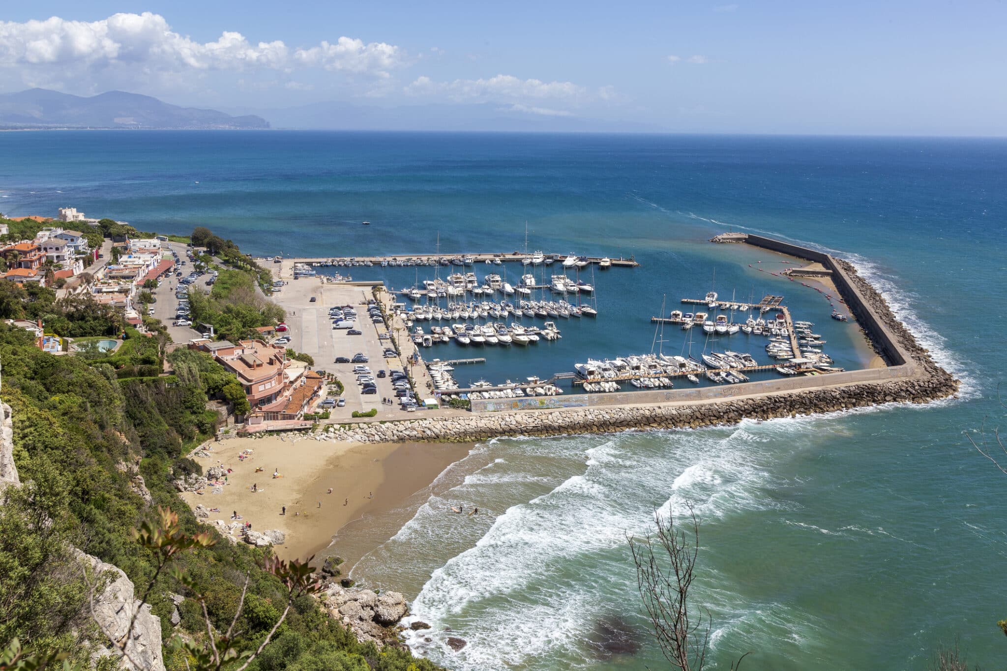 Veduta aerea di porto turistico con spiaggia.